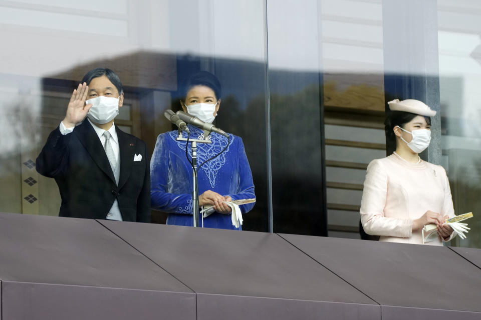 Japan's Emperor Naruhito, from left, Empress Masako and their daughter Princess Aiko greet well-wishers as they appear on the balcony of the Imperial Palace during the emperor's 63rd birthday in Tokyo Thursday, Feb. 23, 2023. (AP Photo/Eugene Hoshiko, Pool)