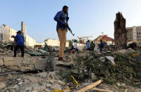 Security officers stand at the scene after a suicide car explosion in front of Doorbin hotel in Mogadishu, Somalia February 24, 2018. REUTERS/Feisal Omar