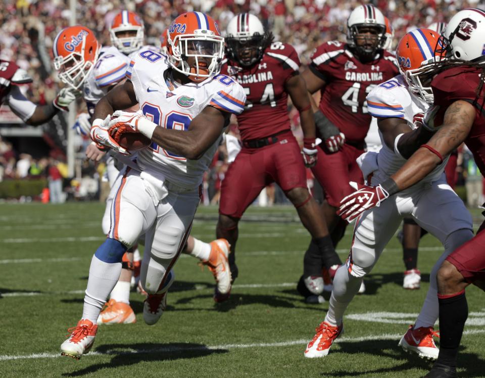 Florida running back Jeff Demps, left, finds a hole in the South Carolina defense as he picks up a first down during the second quarter of an NCAA college football game at Williams-Brice Stadium, in Columbia, S.C., Saturday, Nov. 12, 2011. (AP Photo/Brett Flashnick)