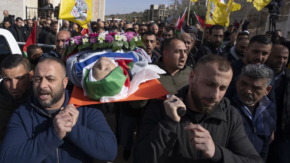 Mourners carry the body of Omar Assad during his funeral in the West Bank village of Jiljiliya, north of Ramallah, on January 13, 2022. - Nasser Nasser/AP