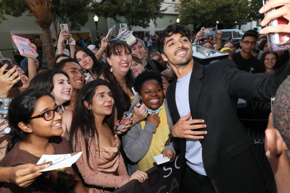 taylor taking a selfie with fans