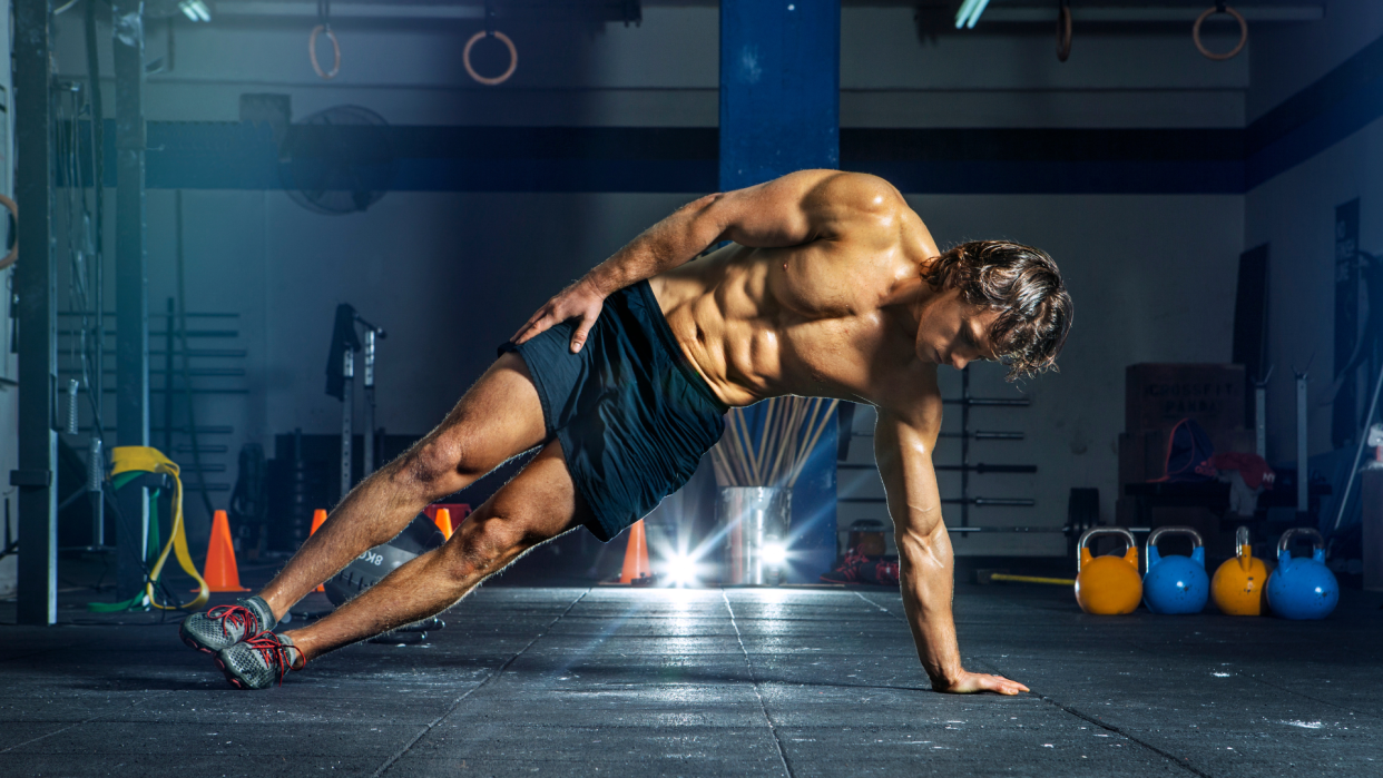  Man performing a side plank for his obliques. 