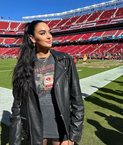 <p>Clare Kittle/Instagram</p> Claire Kittle poses in a vintage T-shirt and leather jacket at Levi's Stadium