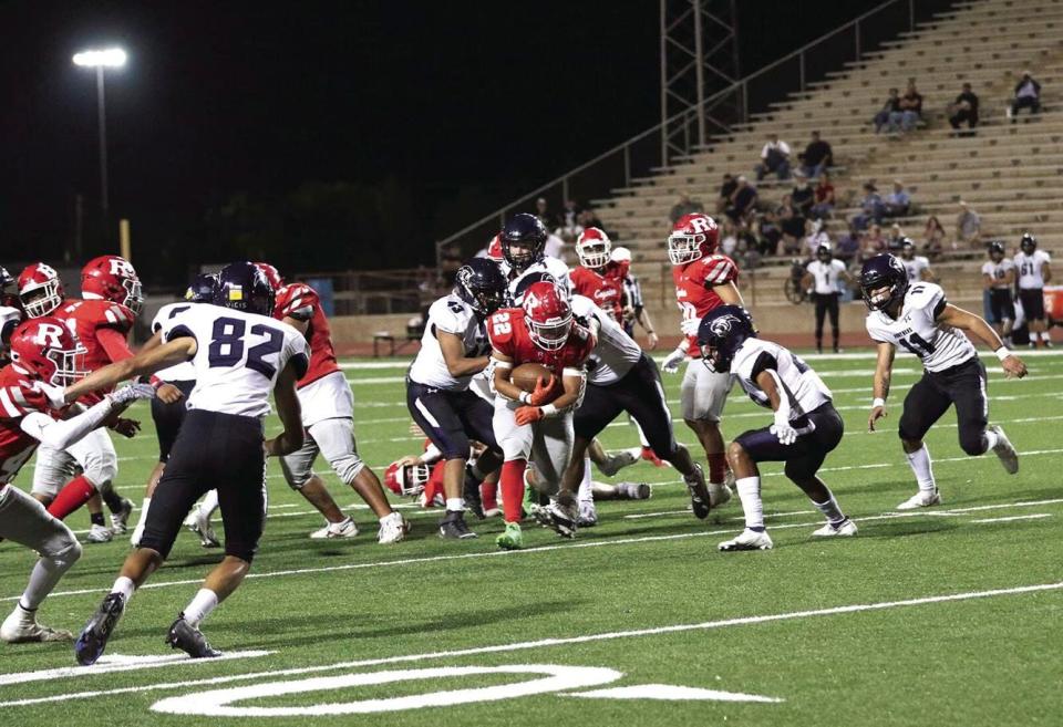 Roswell’s Bryce Sanchez (22) runs through the Piedra Vista defense during a Sept. 30 game at the Wool Bowl.