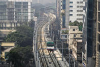 Metro rail speeds along the Paltan-Motijheel route in Dhaka, Bangladesh, Dec. 18, 2023. For decades, political battles in Bangladesh have been fought on the streets, often with violence, by parties led by two powerful women. But there are signs of a generational change as the country of 169 million heads into another general election Sunday. A burgeoning technology industry, lively e-commerce and growing public digital infrastructure are helping one of South Asia’s fastest growing economies capitalize on a tech-savvy workforce which is demanding change from politicians. (AP Photo/Mahmud Hossain Opu)