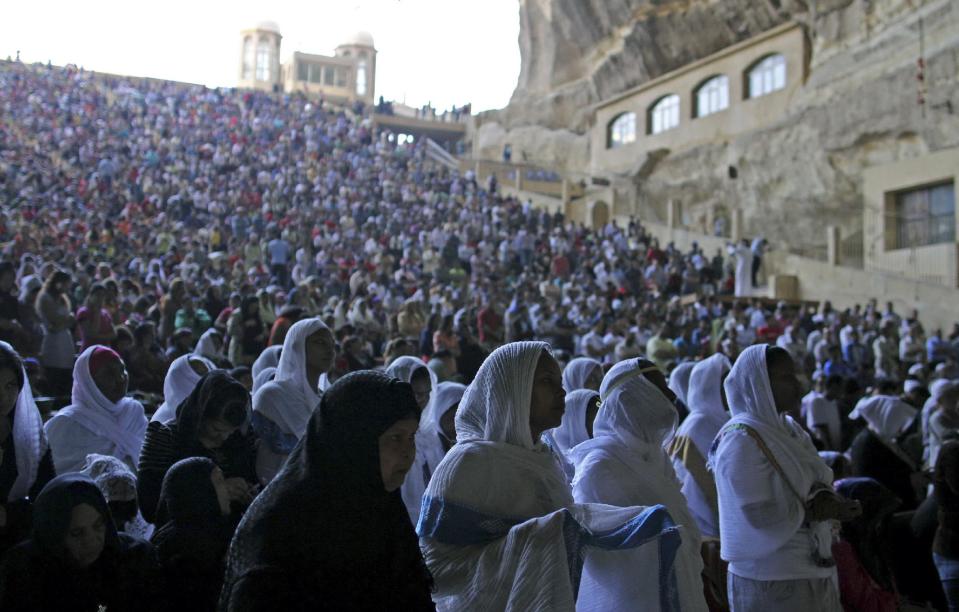 Egyptians celebrate Palm Sunday during a service in the Samaan el-Kharaz Church in the Mokattam district of Cairo, Egypt, Sunday, April 13, 2014. For Christians worldwide, Palm Sunday marks Jesus Christ's entrance into Jerusalem, when his followers laid palm branches in his path, prior to his crucifixion. (AP Photo/Roger Anis, El Shorouk) EGYPT OUT