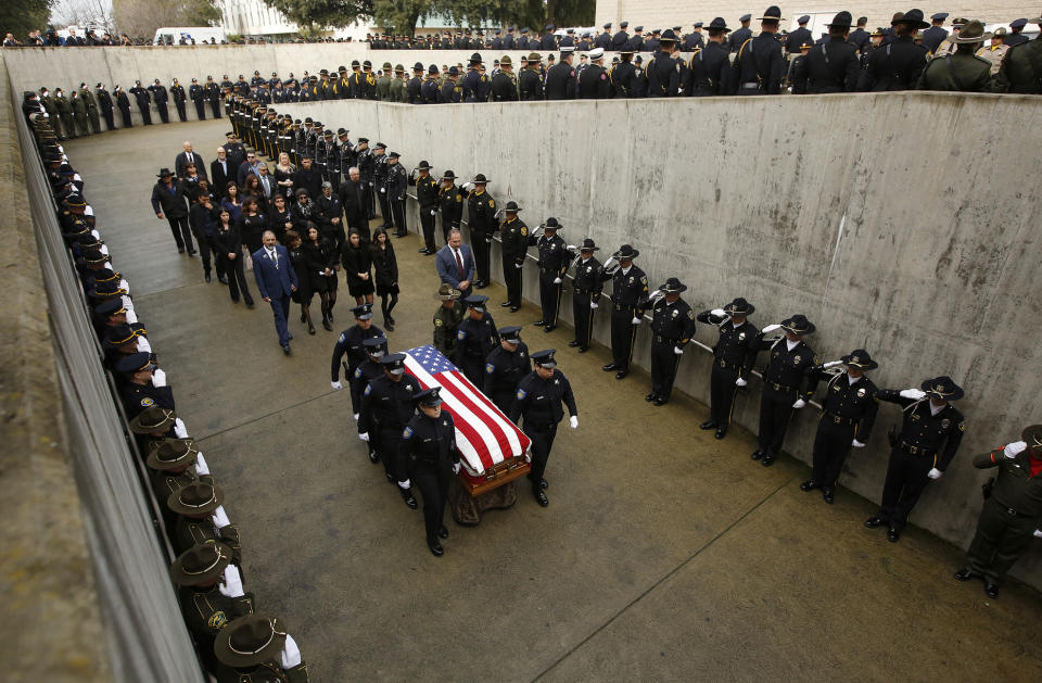 Family members follow the flag draped coffin of Davis Police Officer Natalie Corona before funeral services for Corona at the University of California, Davis, Friday, Jan. 18, 2019, in Davis, Calif. Corona was was shot and killed Jan. 10, responding to scene of a three-car crash in Davis. Police say gunman Kevin Douglas Limbaugh, 48, not involved in the crash, rode up on a bicycle and without warning, opened fire on Corona. (AP Photo/Rich Pedroncelli)