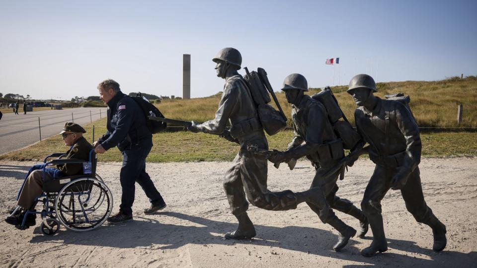An American veteran is wheeled away after a commemoration organized by the Best Defense Foundation at Utah Beach near Sainte-Marie-du-Mont, Normandy, France, Sunday, June 4, 2023, ahead of the D-Day anniversary. (Thomas Padilla/AP)
