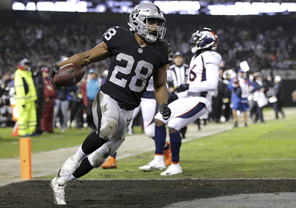 Oakland Raiders running back Doug Martin (28) scores against the Denver Broncos during the first half of an NFL football game in Oakland, Calif., Monday, Dec. 24, 2018. (AP Photo/John Hefti)