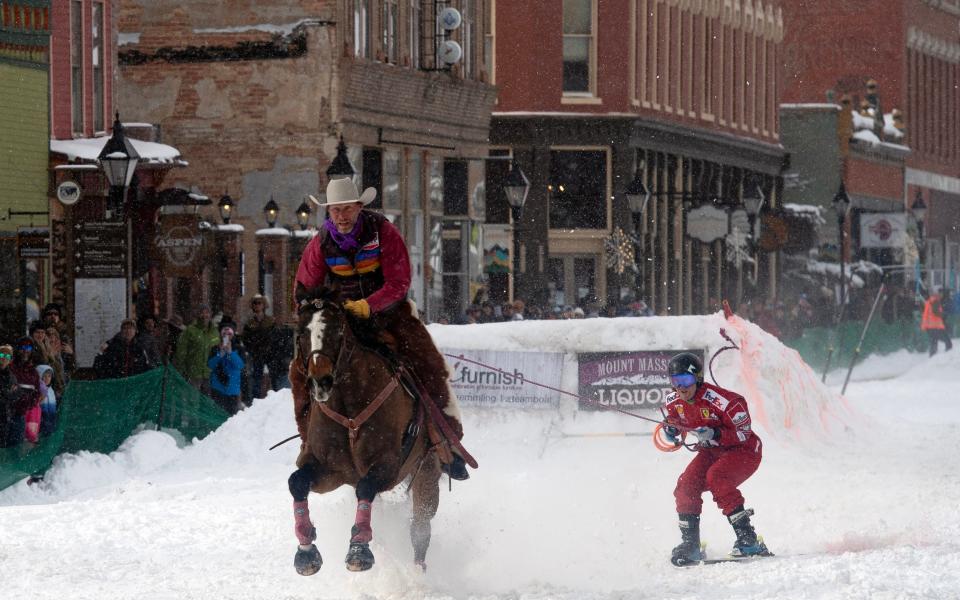 Skier Jack Plantz is pulled down Harrison Avenue along the snowy course