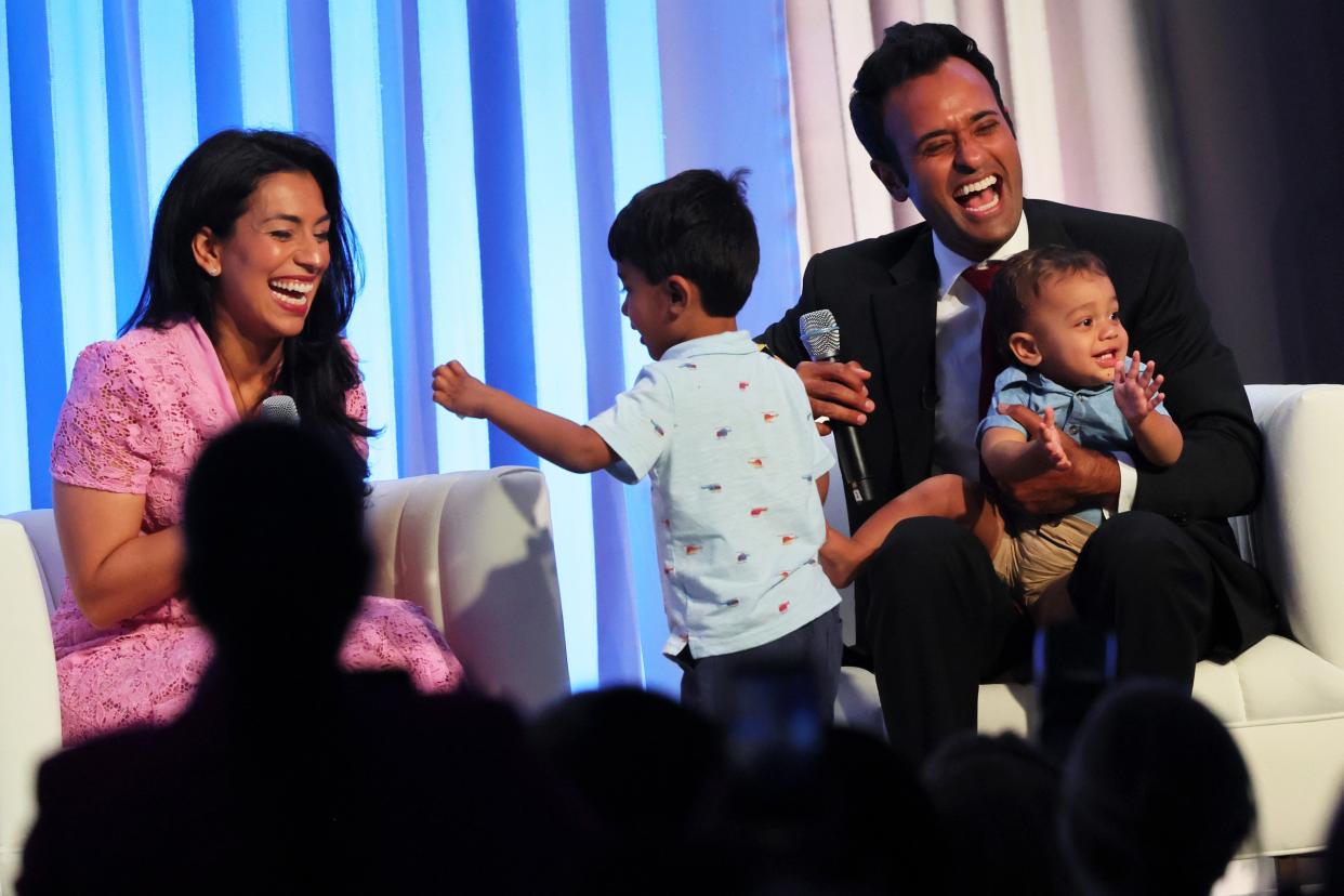 PHILADELPHIA, PENNSYLVANIA - JULY 01: Republican presidential candidate Vivek Ramaswamy laughs as he is joined on stage by his wife Apoorva Ramaswamy and children Karthik and Arjun during the Moms for Liberty Joyful Warriors national summit at the Philadelphia Marriott Downtown on July 01, 2023 in Philadelphia, Pennsylvania. The self-labeled "parental rights" summit is bringing school board hopefuls from across the country where attendees will receive training and hear from Republican presidential candidates which include former U.S. President Trump, Florida Gov. Ron DeSantis and former South Carolina Gov. Nikki Haley. The summit, which is being held in an overwhelmingly Democratic Philadelphia, have drawn protestors since the event was announced due to their pushing of book bans accusing schools of ideological overreach, including teaching about race, gender, and sexuality. (Photo by Michael M. Santiago/Getty Images)