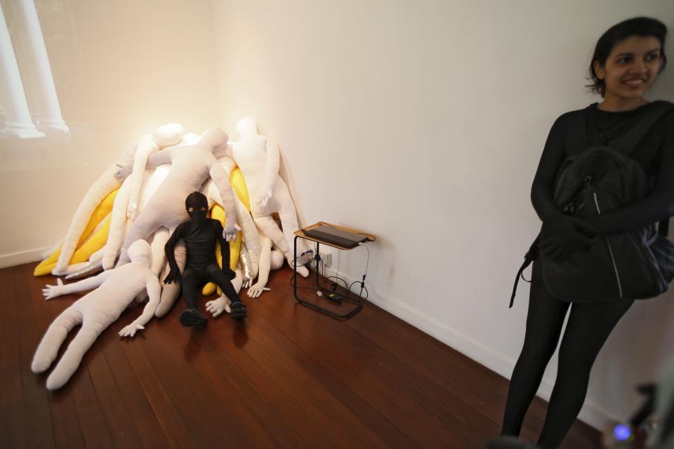 Masaru Morisako (L), a nine-year-old Japanese boy, poses for photos in his Zentai costume, or skin-tight bodysuit from head to toe, before a march down the shopping district of Orchard Road during Zentai Art Festival in Singapore May 23, 2015. Close to 50 participants strutted down the busy shopping district during the Zentai art festival which is jointly organized by the Japanese embassy. The festival includes performances and discussions on Zentai from May 22 to from June 5. REUTERS/Edgar Su