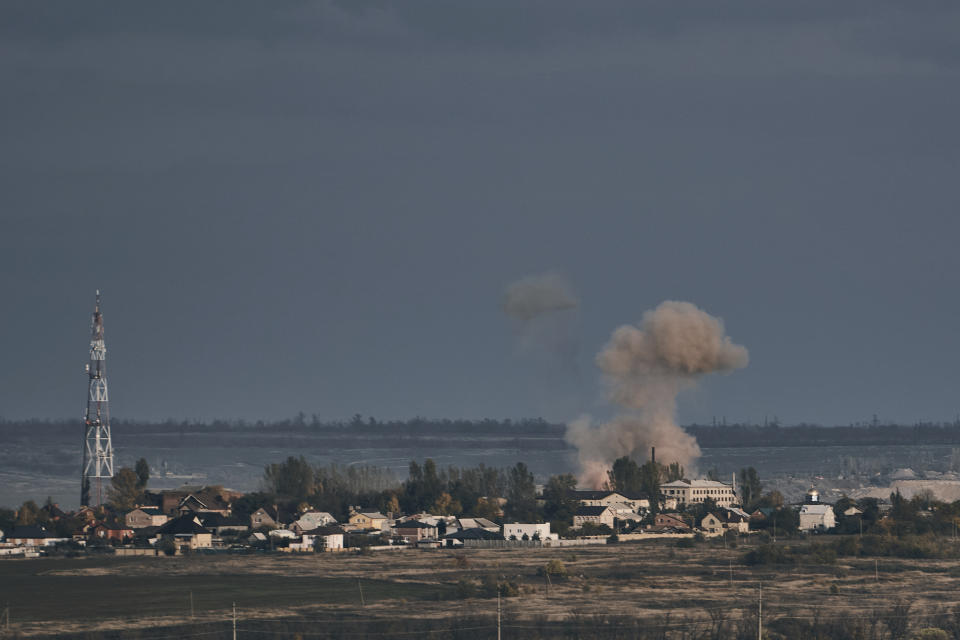 A plume of smoke rises after Russian shelling in Bakhmut, Donetsk region, Ukraine, Saturday, Oct. 22, 2022. (AP Photo/LIBKOS)