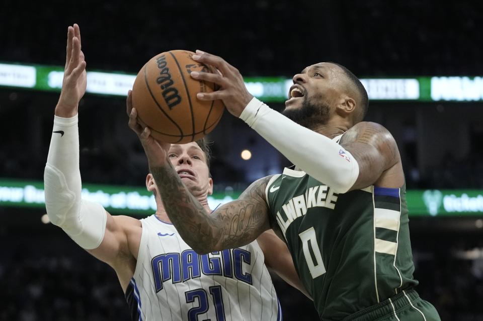 Milwaukee Bucks' Damian Lillard shoots past Orlando Magic's Moritz Wagner during the second half of an NBA basketball game Thursday, Dec. 21, 2023, in Milwaukee. The Bucks won 118-114. (AP Photo/Morry Gash)