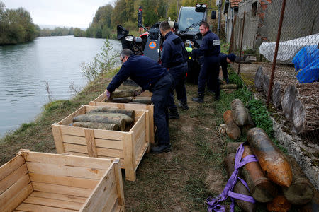 Deminers from a bomb-disposal unit place in boxes unexploded shells recovered in the Meuse River at Sivry-sur-Meuse, close to WWI battlefields, near Verdun, France, October 24, 2018 before the centenial commemoration of the First World War Armistice Day. REUTERS/Pascal Rossignol