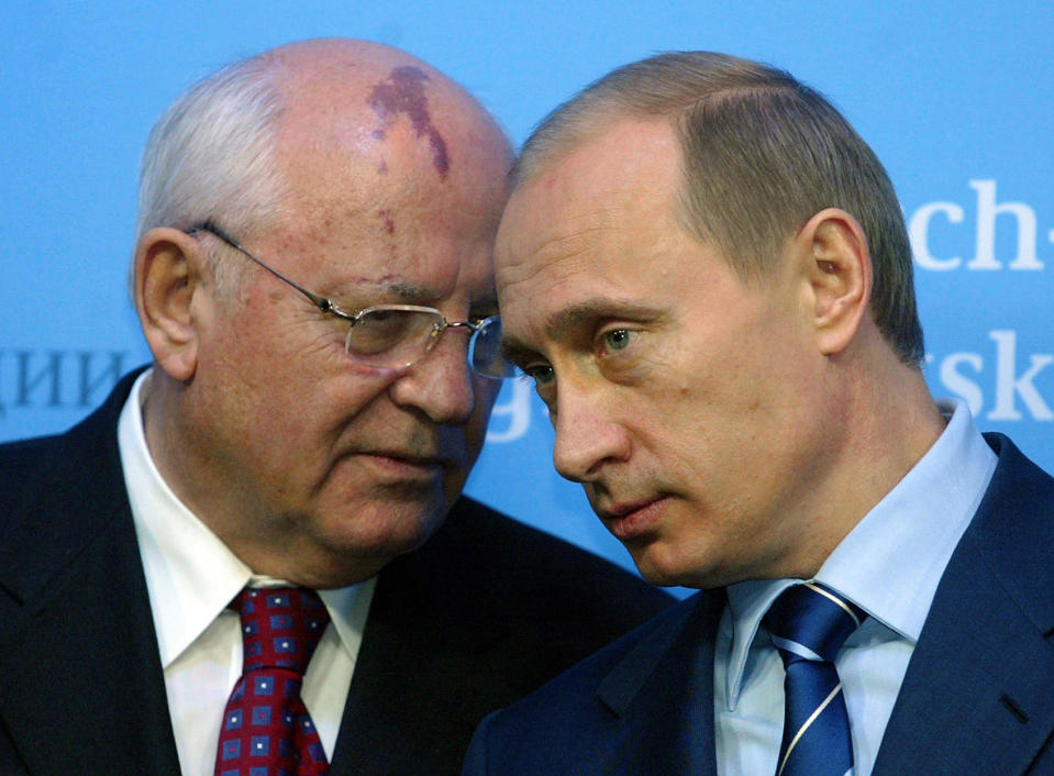 Russian President Vladimir Putin (R) talks to former Soviet President Mikhail Gorbachev on December 21, 2004, before a press conference with German Chancellor Gerhard Schroeder and Putin at Gottorf castle in Schleswig, Germany. / Credit: JOCHEN LUEBKE/DDP/AFP/Getty