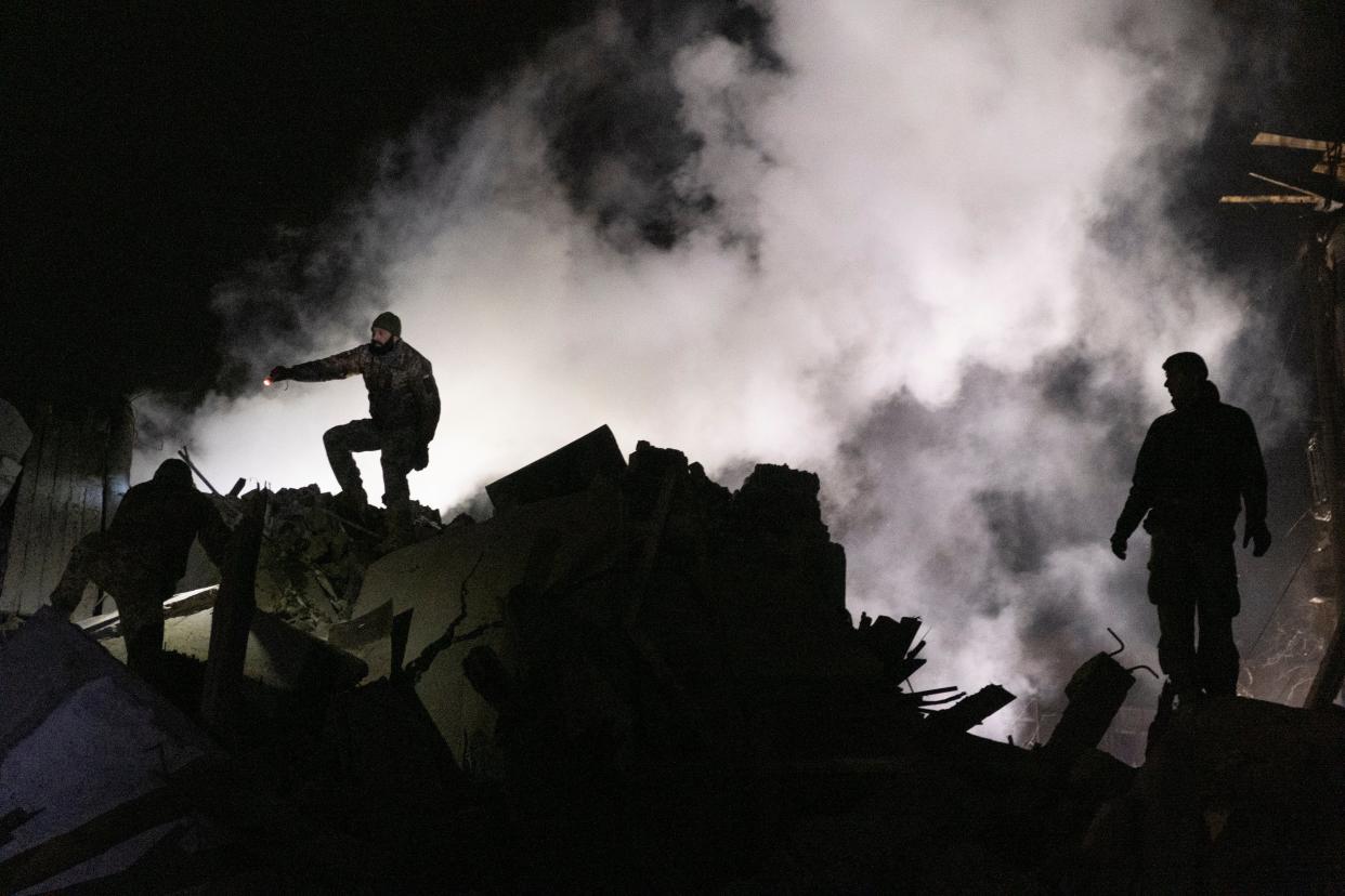 Rescuers search the rubble for a missing person (EPA)