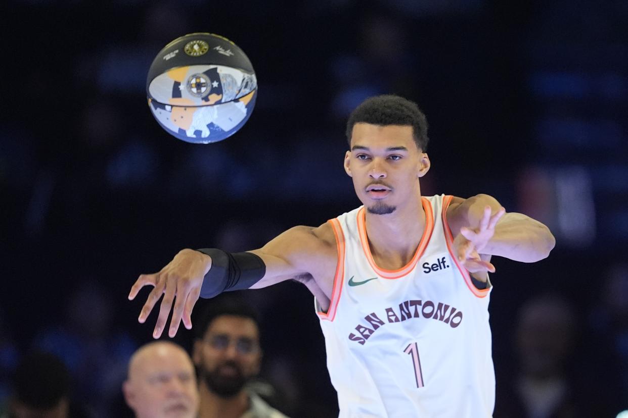 San Antonio Spurs' Victor Wembanyama throws a pass during the skills challenge at the NBA basketball All-Star weekend, Saturday, Feb. 17, 2024, in Indianapolis. (AP Photo/Darron Cummings)