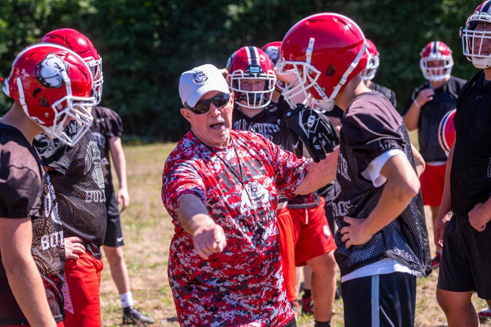 Old Rochester offensive line coach Craig Sherman works with the team during preseason.