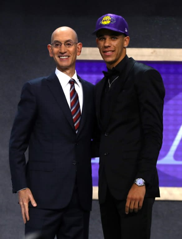 Lonzo Ball (R) poses on stage with NBA commissioner Adam Silver after being drafted second overall by the Los Angeles Lakers during the first round of the 2017 NBA Draft, at Barclays Center in New York, on June 22