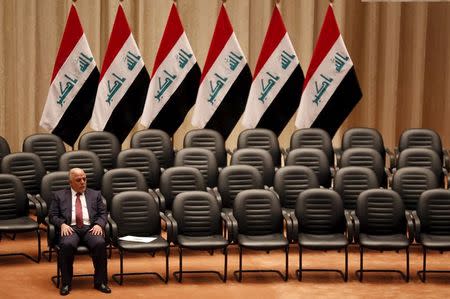 Iraq's new premier Haider al-Abadi sits during a parliamentary session to vote on Iraq's new government at the parliament headquarters in Baghdad, Iraq in this September 8, 2014 file photo. REUTERS/Thaier Al-Sudani/Files