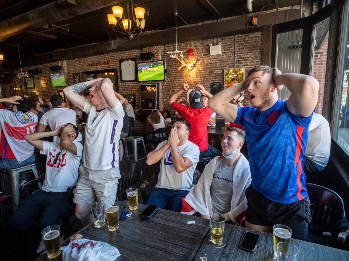 Soccer fans react while watching a UEFA World Cup match between England and Scotland at the London Pub in Vancouver, B.C., on Friday, June 18, 2021. (Ben Nelms/CBC - image credit)