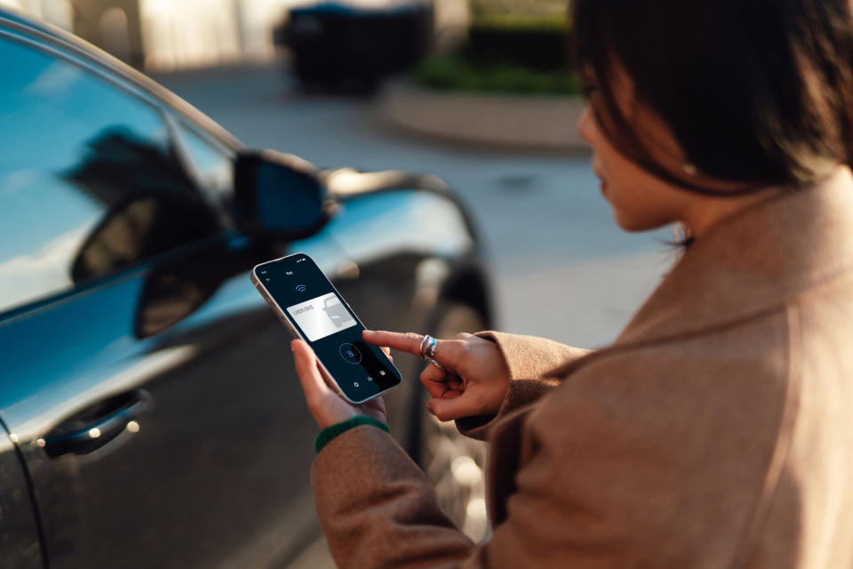 Person using a smartphone app to unlock a car door