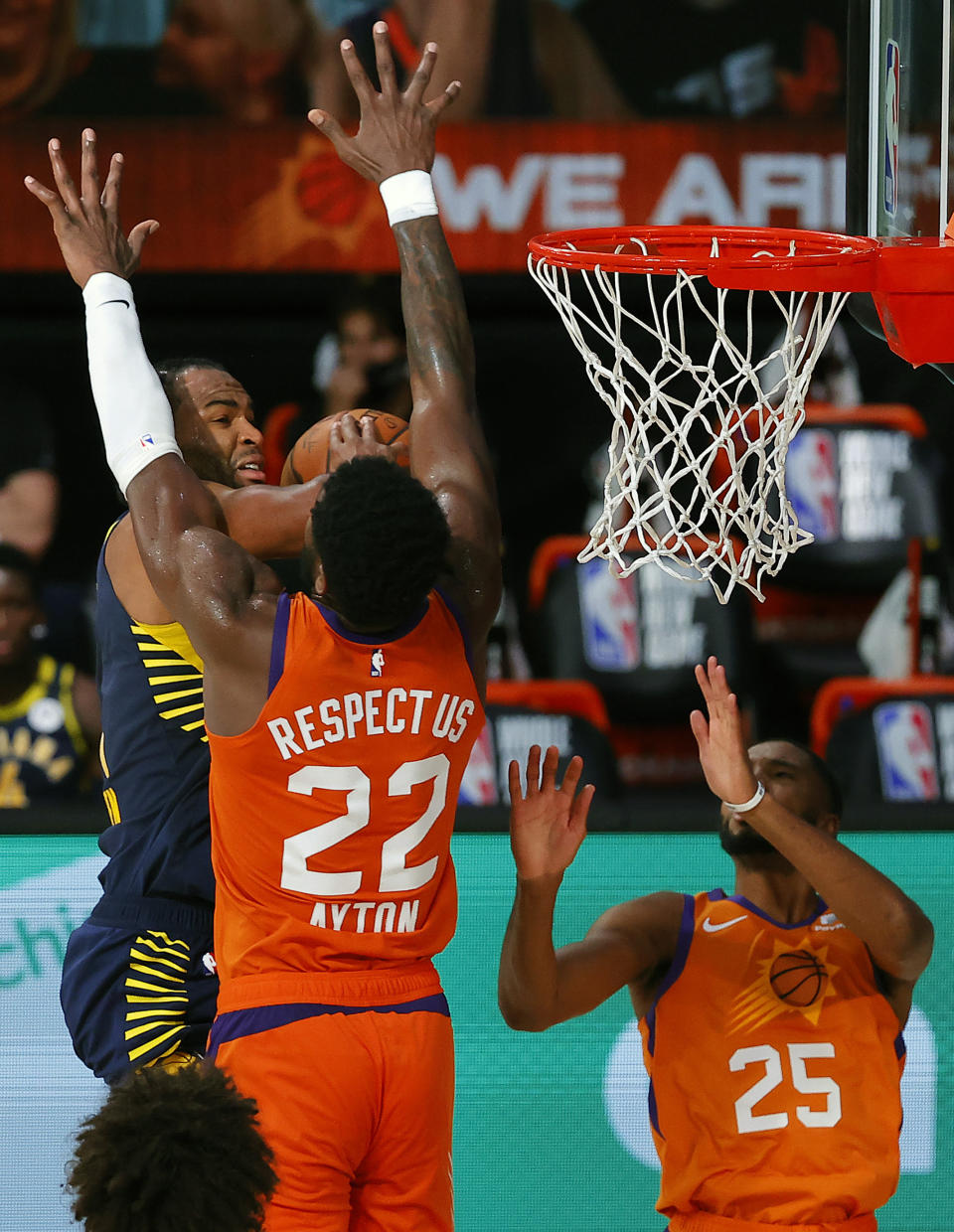 Indiana Pacers' T.J. Warren #1 is defended by Phoenix Suns' Deandre Ayton (22) and Mikal Bridges (25) during the second half of an NBA basketball game Thursday, Aug. 6, 2020, in Lake Buena Vista, Fla. (Kevin C. Cox/Pool Photo via AP)