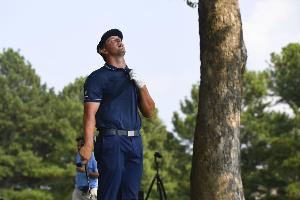 Bryson Dechambeau jokes with spectators as he waits for a helicoptor to fly over before taking a shot on the 17th hole during the third round in the World Golf Championship-FedEx St. Jude Invitational tournament, Saturday, Aug. 7, 2021, in Memphis, Tenn. (AP Photo/John Amis)
