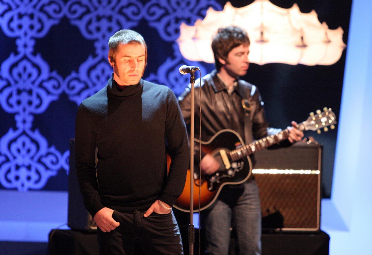 Liam Gallagher and Noel Gallagher performing with Oasis on stage in Germany in February 2009. (Getty Images)