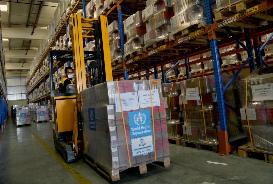 A forklift driver loads healthcare materials to be sent to Afghanistan at a UNHCR warehouse, part of the International Humanitarian City in Dubai, United Arab Emirates, Monday, June 27, 2022. (AP Photo/Kamran Jebreili)