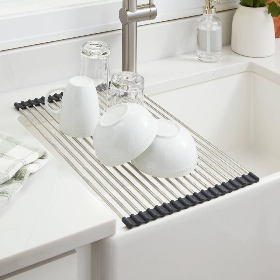 The rack placed over a sink with dishing resting on it