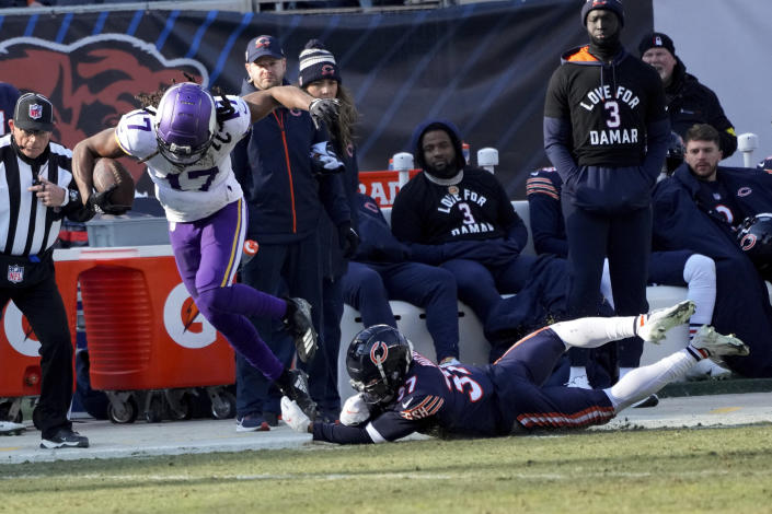 Minnesota Vikings wide receiver K.J. Osborn (17) is tackled by Chicago Bears safety Elijah Hicks (37) after catching a pass during the first half of an NFL football game, Sunday, Jan. 8, 2023, in Chicago. (AP Photo/Charles Rex Arbogast)