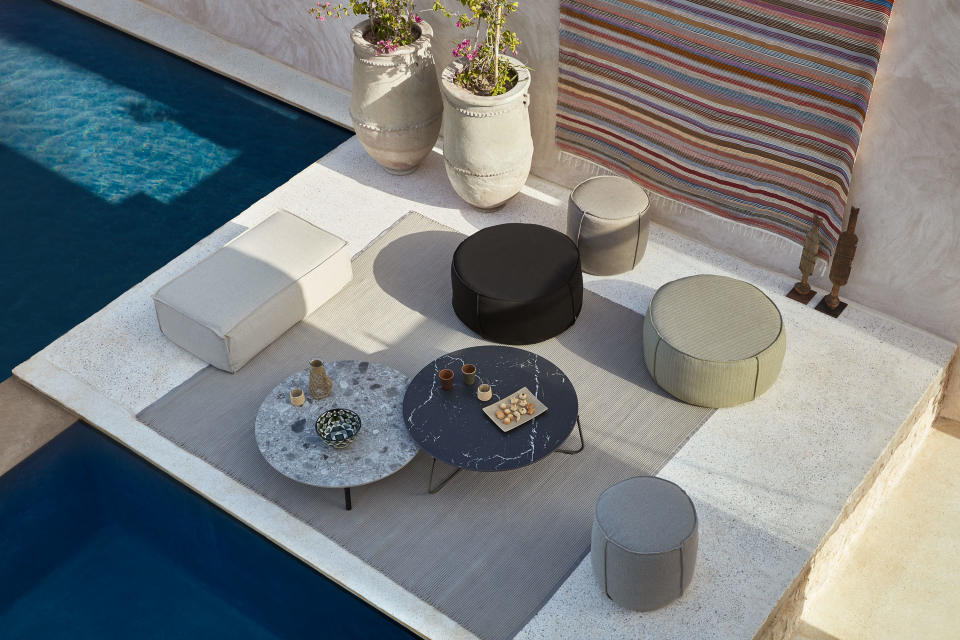 Create a tranquil patio scene with outdoor poufs