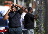 Family members of victims and employees gather outside of a post office after a shooting, Tuesday, Oct. 12, 2021 in the Orange Mound neighborhood of Memphis, Tenn. Police investigated a shooting Tuesday at a post office in an historic neighborhood of Memphis, Tennessee, the third high-profile shooting in the region in weeks.(Patrick Lantrip/Daily Memphian via AP)