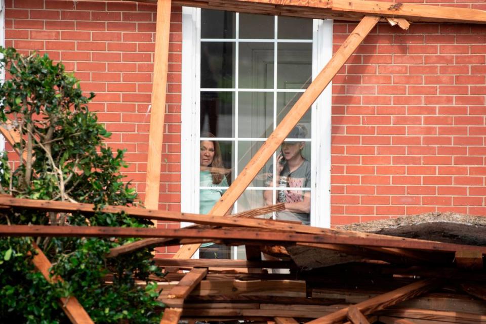 Bank employees survey damage of Merchants and Marine Bank in Moss Point on Tuesday, June 20, 2023, after a tornado damaged the building on Monday, trapping workers inside.