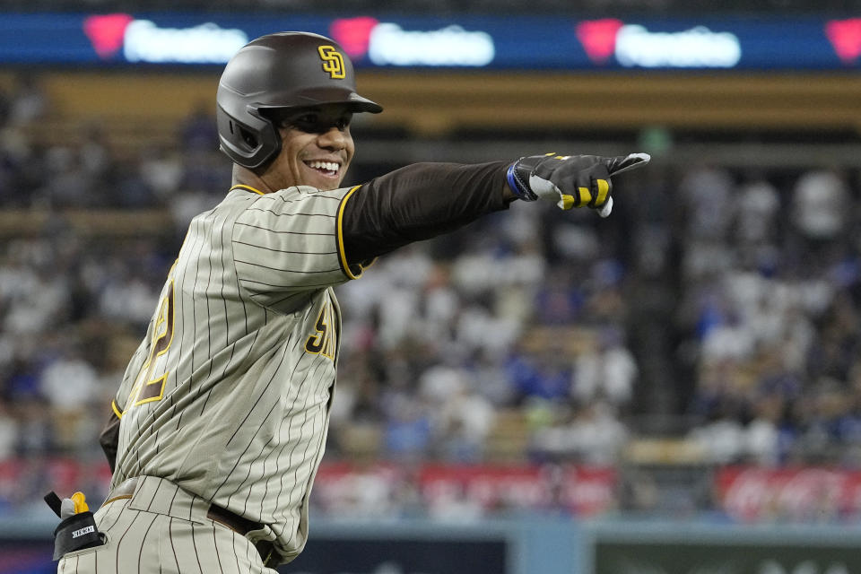 San Diego Padres' Juan Soto points toward his dugout after hitting a solo home run during the first inning of a baseball game against the Los Angeles Dodgers Wednesday, Sept. 13, 2023, in Los Angeles. (AP Photo/Mark J. Terrill)