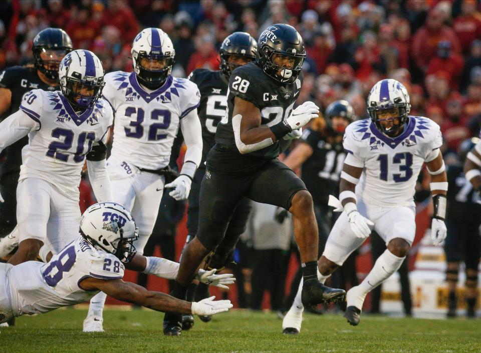 Iowa State junior running back Breece Hall breaks the tackle of TCU safety Nook Bradford en route to the end zone for a touchdown in the second quarter on Friday, Nov. 26, 2021, at Jack Trice Stadium in Ames.