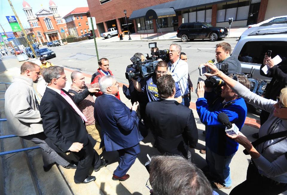 Robert K. Mericle, center, leaves the William J. Nealon Federal Building and U.S. Courthouse in Scranton, Pa., after being sentenced to one year in prison on Friday, April 25, 2014. Mericle, a builder of for-profit youth detention centers, was sentenced for his role in a "kids for cash" scandal in which thousands of juveniles were sent to his facilities by judges who took money from him. He was also fined $250,000 and ordered to serve 100 hours of community service. (AP Photo/ The Times-Tribune, Jake Danna Stevens) WILKES BARRE TIMES-LEADER OUT; MANDATORY CREDIT