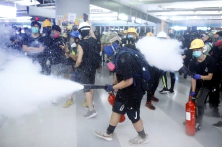 Protest at Yuen Long MTR station, the scene of an attack by suspected triad gang members a month ago, in Hong Kong