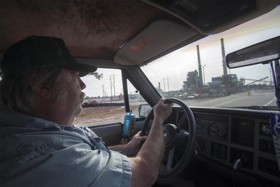 Flemington Road community resident Kenneth Sandlin of Wilmington, N.C., drives by the L.V. Sutton Complex operated by Duke Energy on Wednesday, Feb. 19, 2014. Sandlin is part of the small community that feels nearby Sutton Lake and well water could be polluted from spill off and seepage from large coal ash ponds at the facility. In the wake of Duke Energy’s massive coal ash spill in Eden, people in the Flemington community are paying close attention to the environmental disaster unfolding 200 miles to the northwest along the Dan River. (AP Photo/Randall Hill)