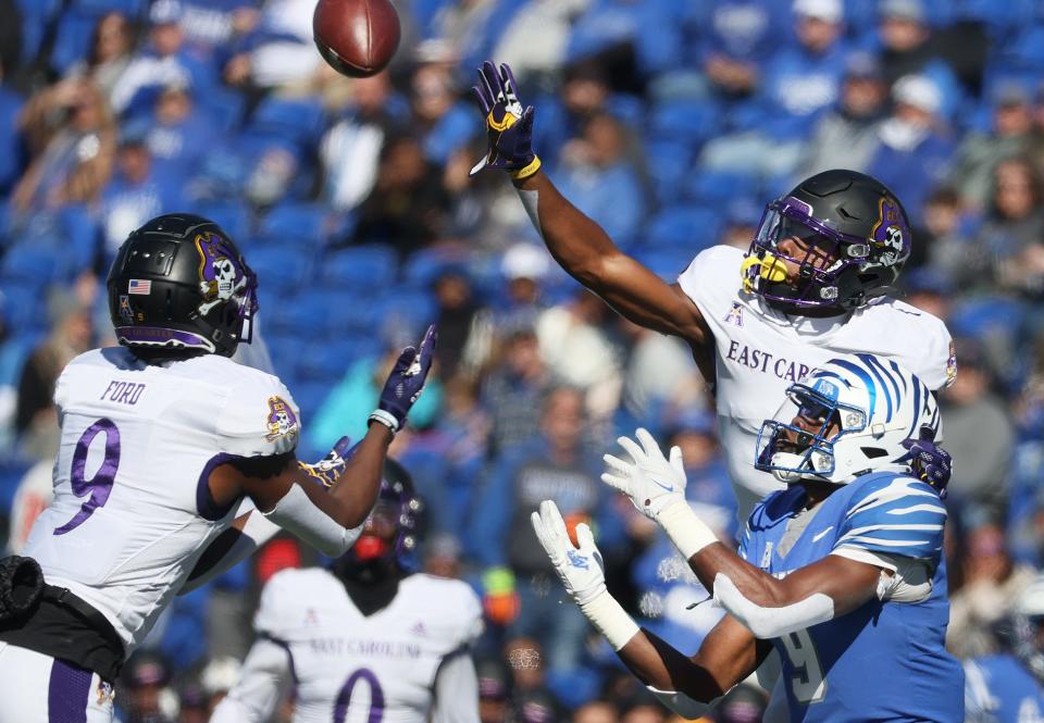 Memphis Tigers running back Gabriel Rogers attempts to catch a pass as ECU Pirates defenders D.J. Ford, left, and Malik Fleming swarm to the ball during their game at Liberty Bowl Memorial Stadium on Saturday, Nov. 13, 2021. 