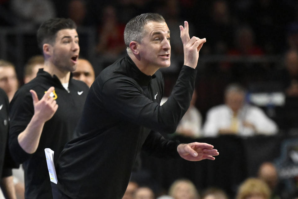 San Francisco head coach Chris Gerlufsen signals to his team during the first half of an NCAA college basketball game against Gonzaga in the semifinals of the West Coast Conference men's tournament Monday, March 6, 2023, in Las Vegas. (AP Photo/David Becker)