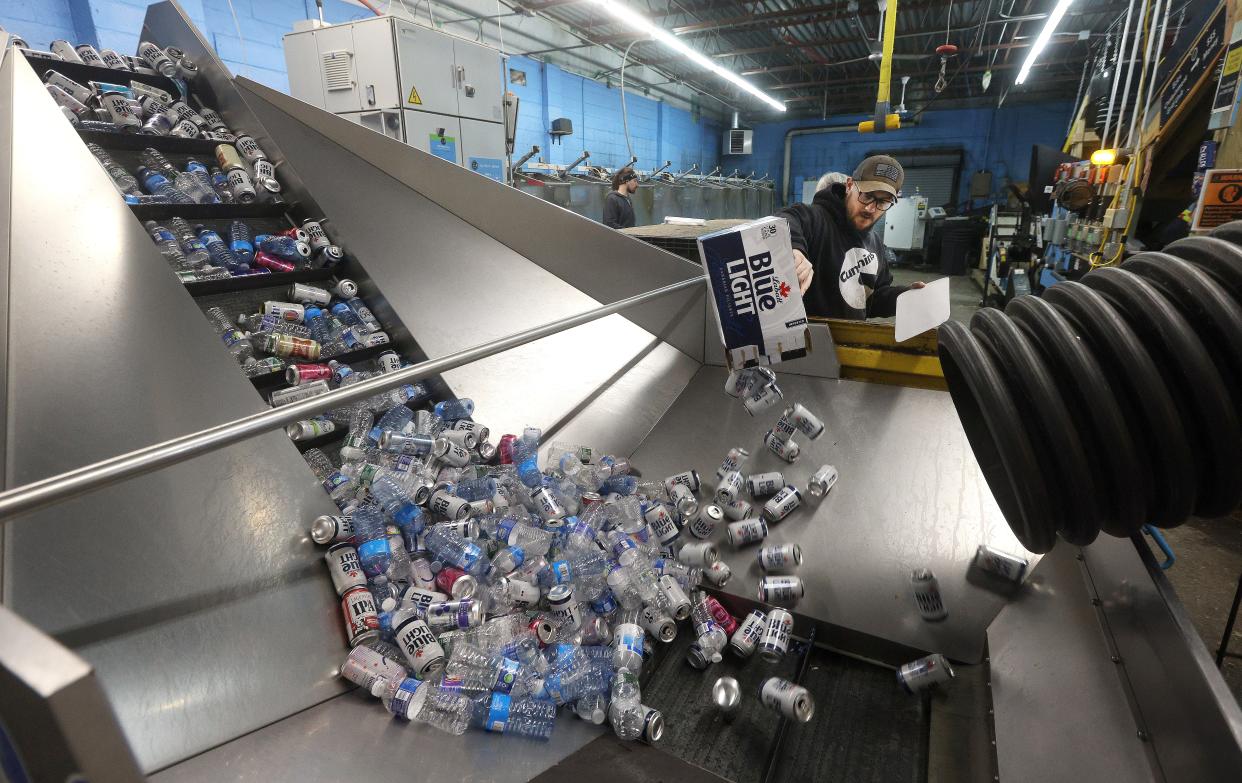 Cans are loaded in a sorting machine at Can Bottle Return Company in Hamburg, New York. The can will be sorted by branding and bagged for transport.