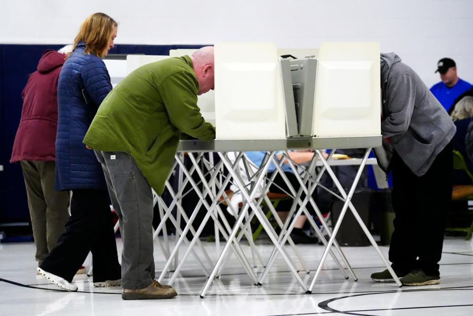 David Taylor, center, Republican candidate in Ohio’s 2nd Congressional District race, votes in the primary at Holly Hill Elementary in Amelia, Tuesday, March 19, 2024.