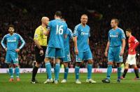 Sunderland's Wes Brown (3rd R) is sent off by the referee (2nd L) instead of Sunderland's John O'Shea (3rd L) during the English Premier League football match between Manchester United and Sunderland in Manchester, England, on February 28, 2015