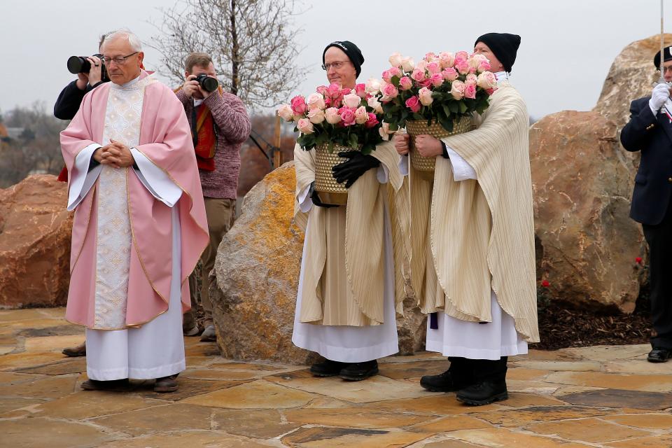The Rev. Don Wolf, left, stands with other clergy Dec. 11 during an outdoor Mass and dedication of Tepeyac Hill at the Blessed Stanley Rother Shrine in Oklahoma City.