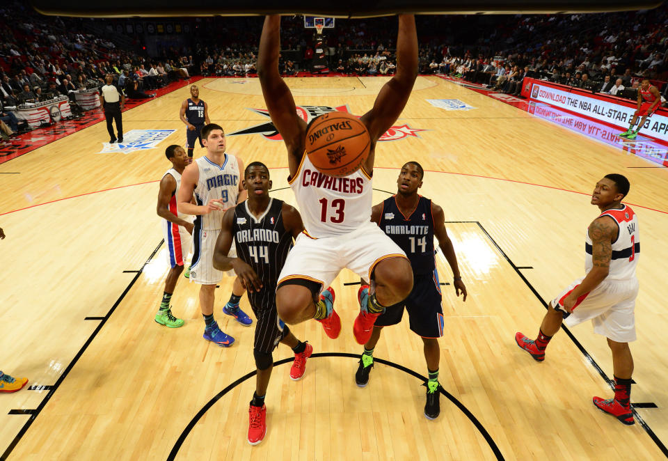 Cleveland Cavaliers Tristan Thompson (13) hangs on the rim after a dunk during the first half of the NBA BBVA Rising Star Challenge basketball game in Houston, Texas, February 15, 2013. REUTERS/Bob Donnan/Pool (UNITED STATES - Tags: SPORT BASKETBALL) - RTR3DUYA