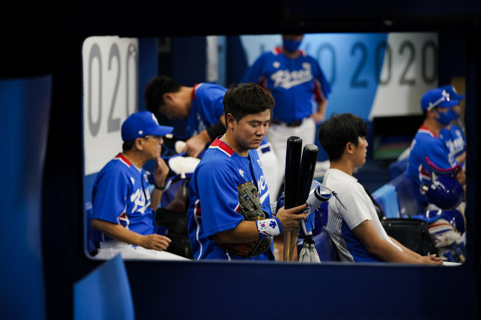 South Korea's Joohwan Choi packs up after a semi-final baseball game against the United States at the 2020 Summer Olympics, Thursday, Aug. 5, 2021, in Yokohama, Japan. The United States won 7-2. (AP Photo/Sue Ogrocki)