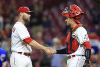 Cincinnati Reds' Hunter Strickland, left, shakes hands with Aramis Garcia after the final out of the team's baseball game against the Chicago Cubs in Cincinnati, Wednesday, May 25, 2022. The Reds won 4-3. (AP Photo/Aaron Doster)